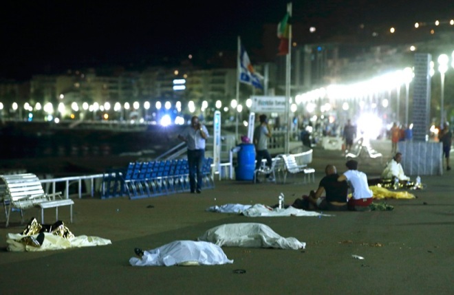 Bodies are seen on the ground after at least 30 people were killed in the southern French town of Nice when a truck ran into a crowd celebrating the Bastille Day national holiday